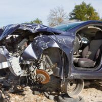 a dark blue car after of a head on collision